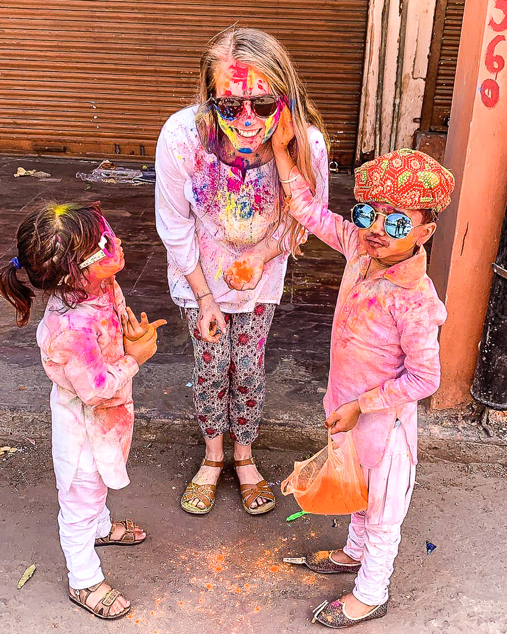 Celebrating Holi festival with colored paint in the streets of the Pink City