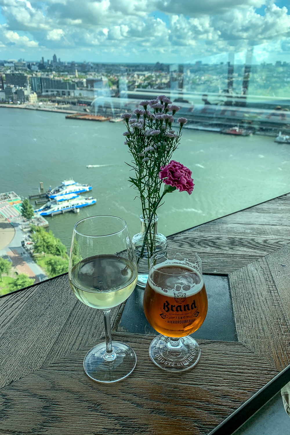 A white wine and beer with a high up view of a wharf in Amsterdam
