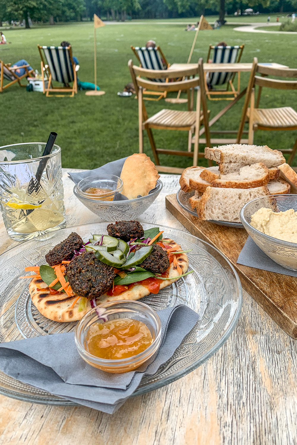 Falafel, pitas, humous and breads on a table in a park