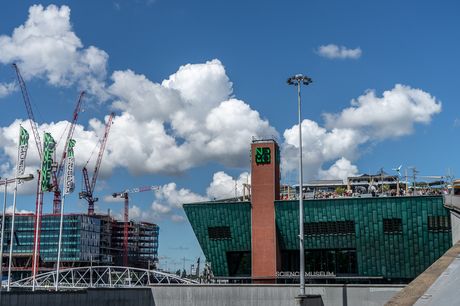 NEMO science museum in Amsterdam, an industrial looking building with cranes nearby
