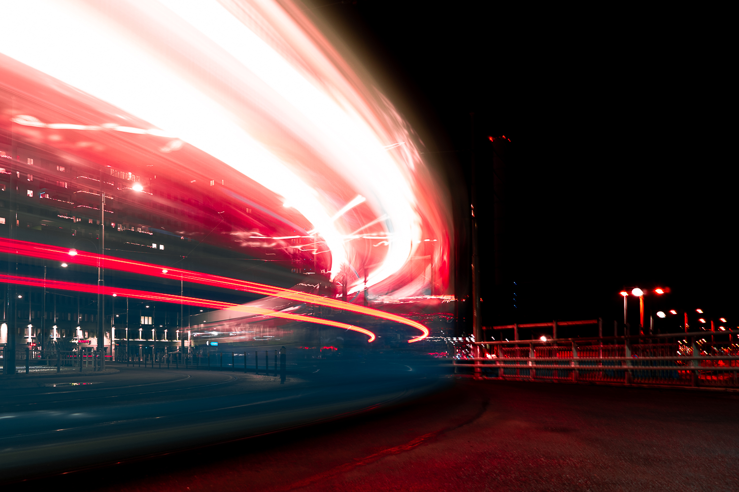Long exposure of a city tram with streaked red lights