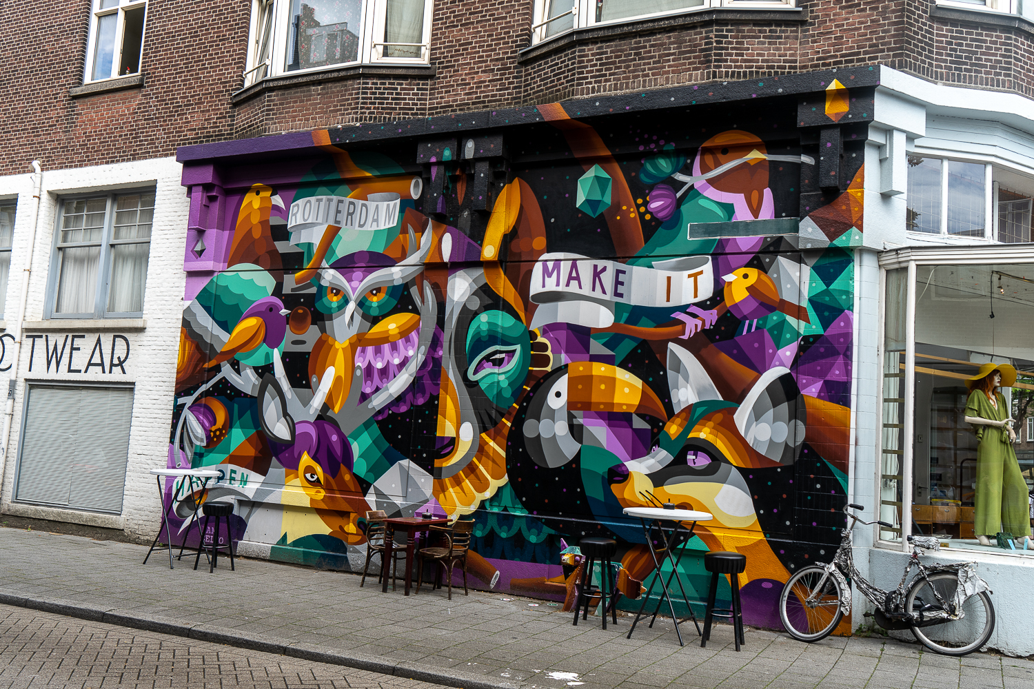 Vibrant purple, orange and green street art of animals using geometric style