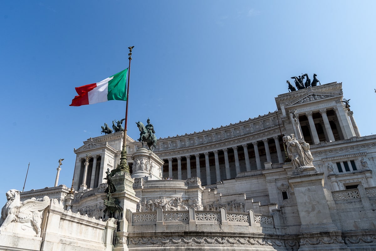 An Italian flag in front of Victor Emmanuel II Monument at Altare della Patria (Altar of the Fatherland) in Rome.