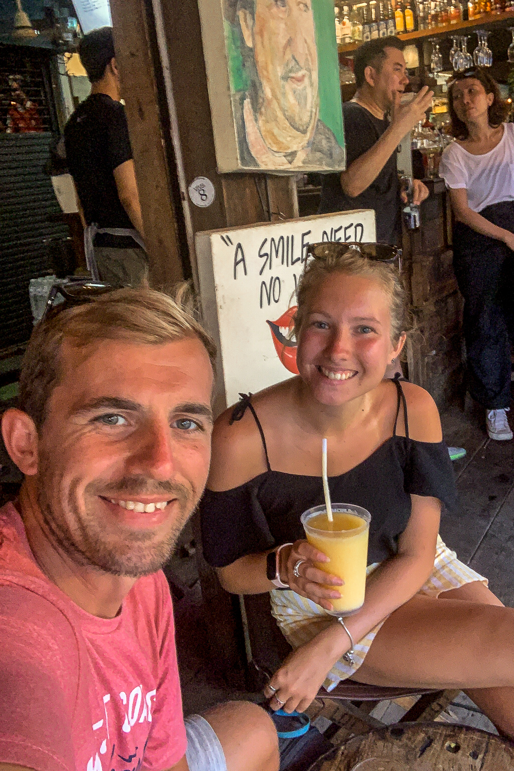 A couple enjoying mango cocktails in a wooden bar