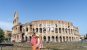 A couple taking in the beauty of the Colosseum in Rome, Italy.