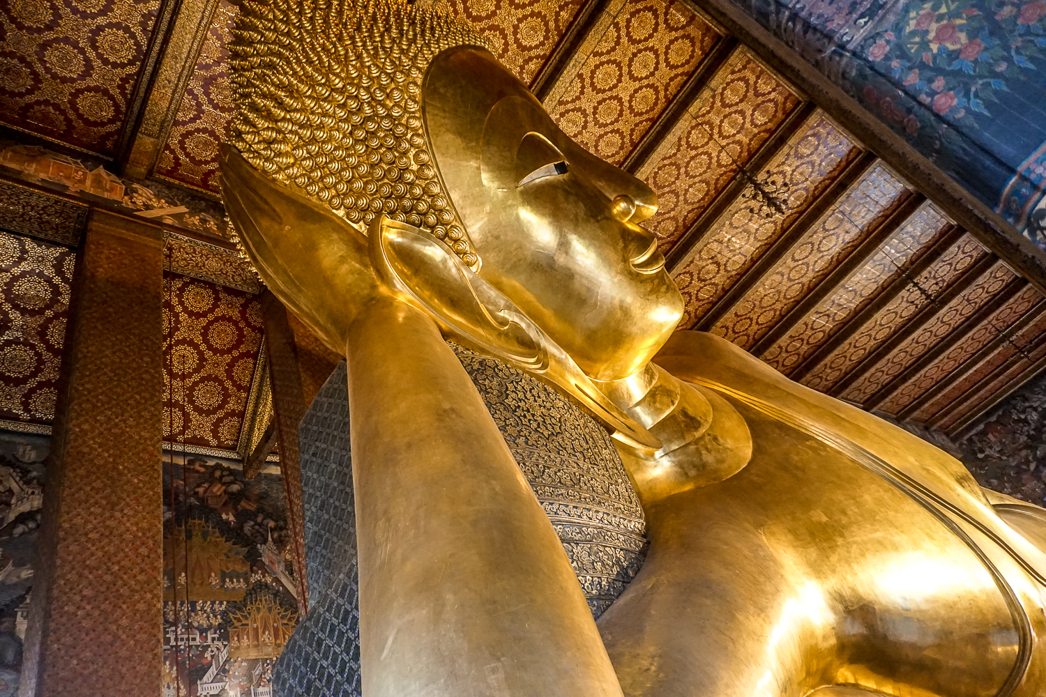 A huge golden Buddha statue in the reclining position