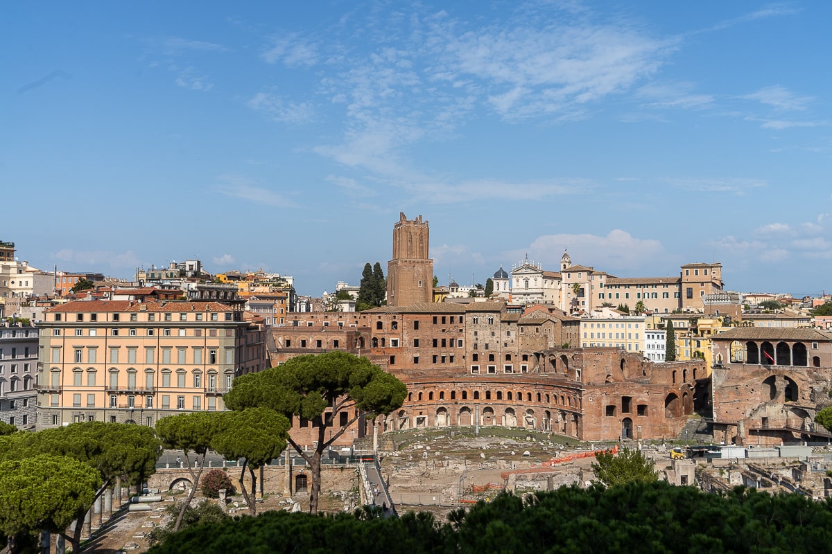 An iconic landmark of ancient Rome - the Forum - stands tall amidst the bustling cityscape.