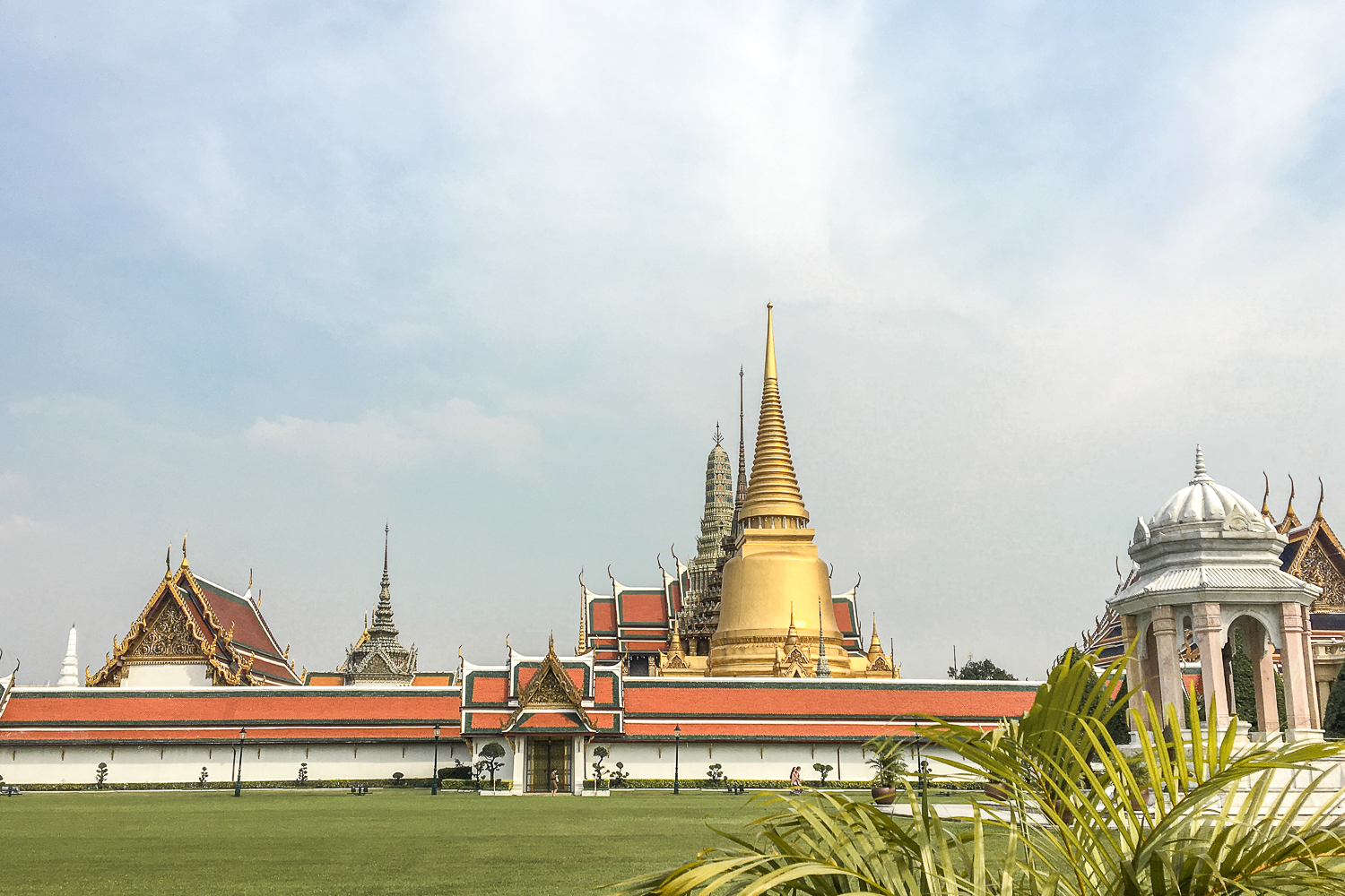 Wide view of the Temple of the Emerald Buddha in Bangkok - large golden spiked roofs