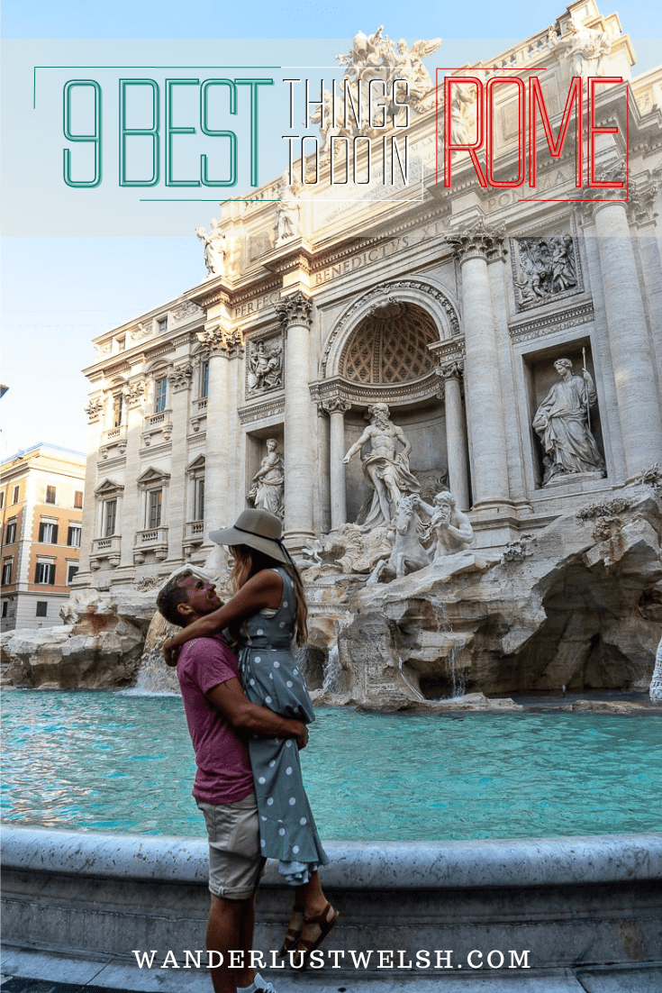A couple embracing in front of Trevi Fountain.