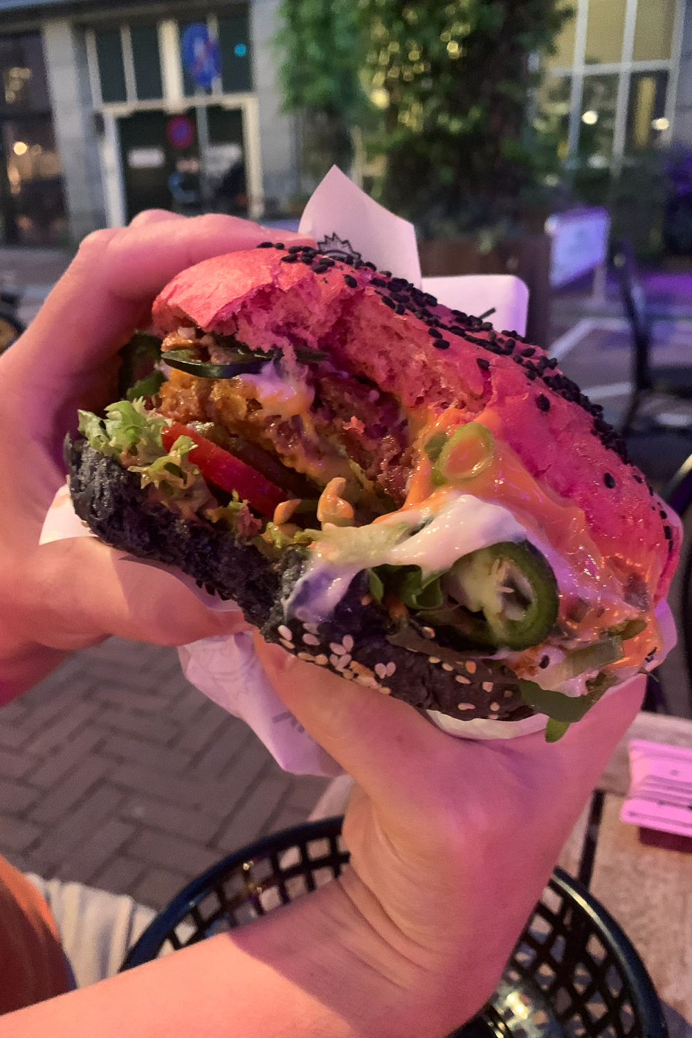 Huge vegan burger with bite taken out of it