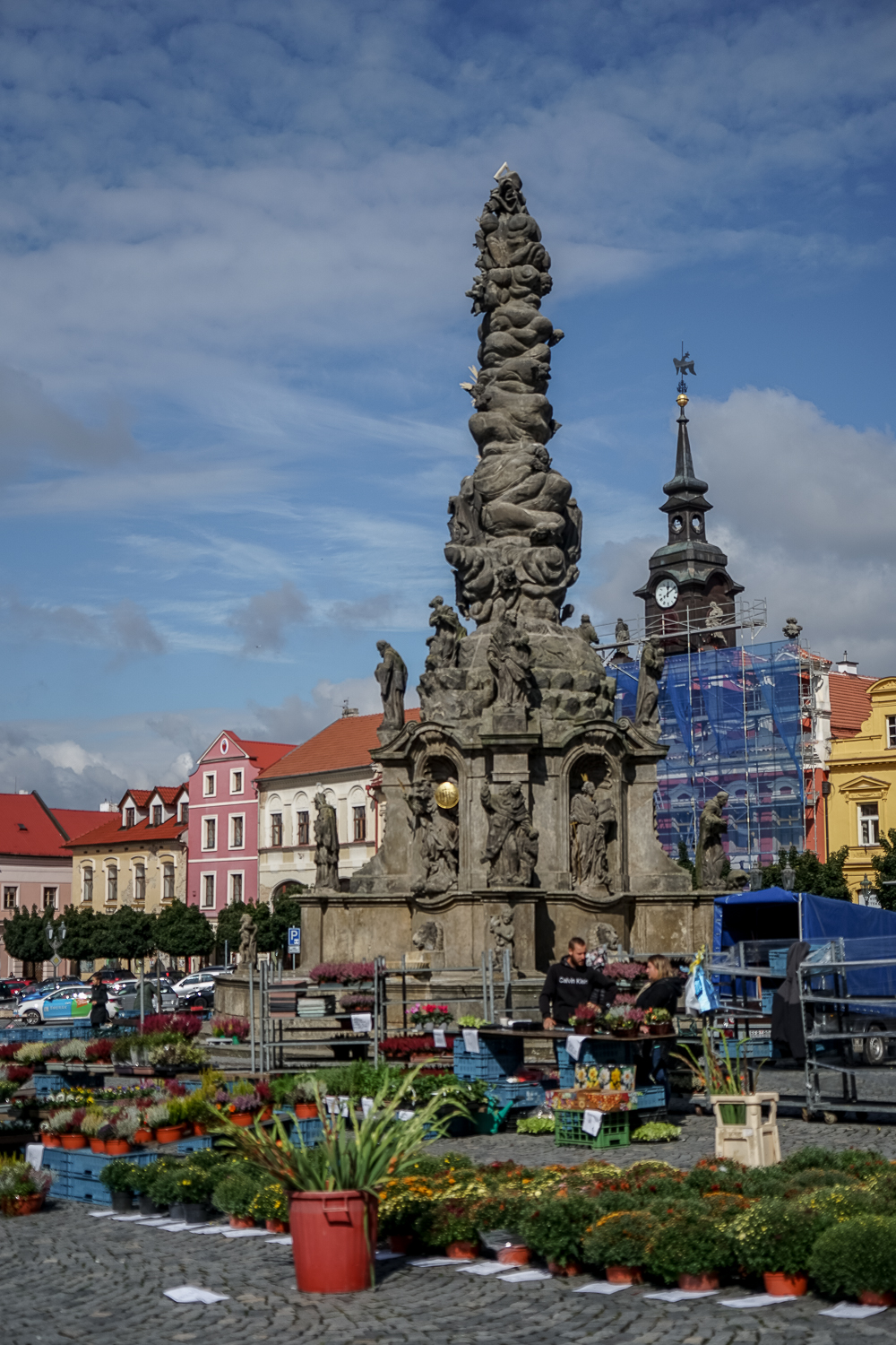 A quaint town square with flower stalls