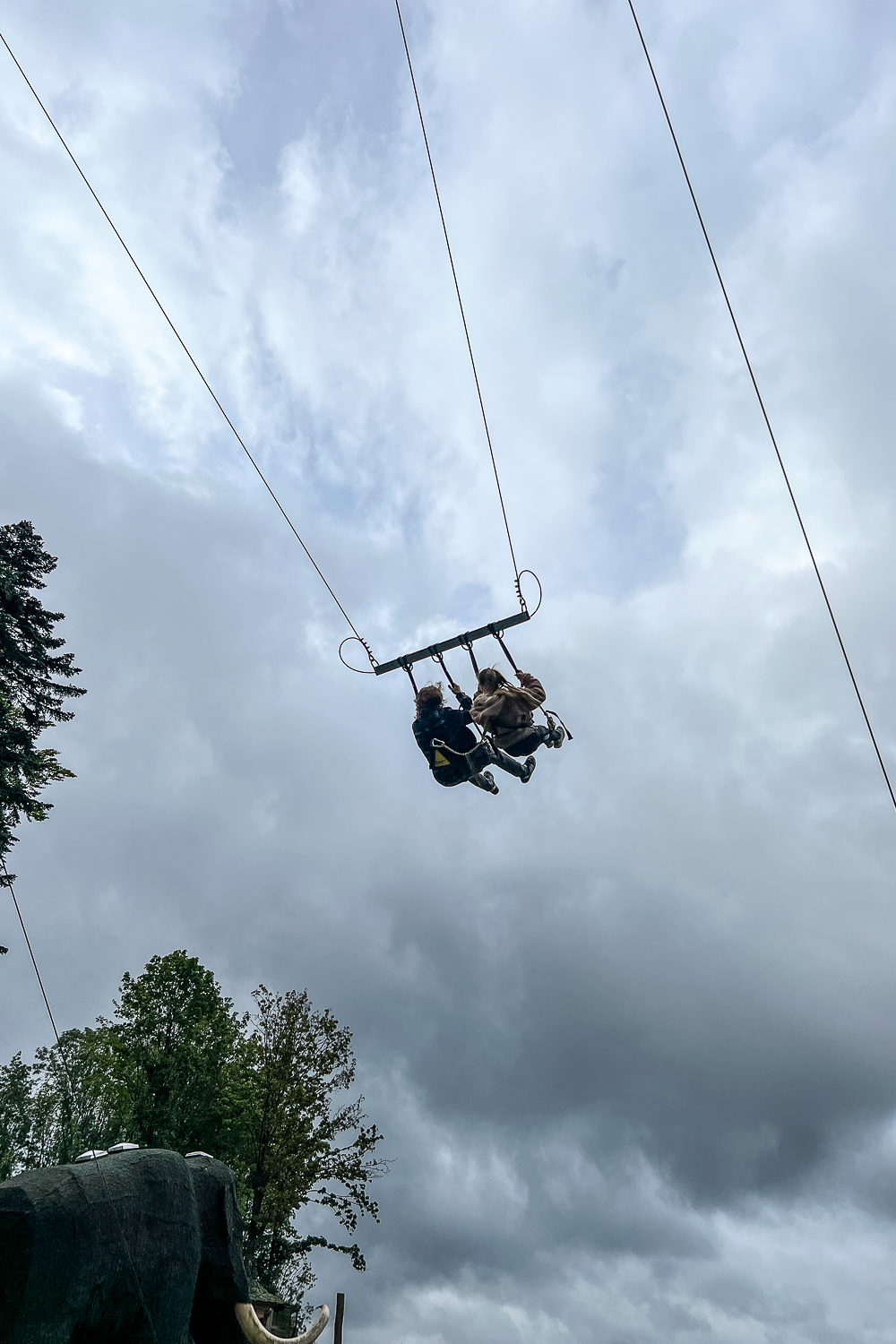 Couple high above the ground on a huge swing