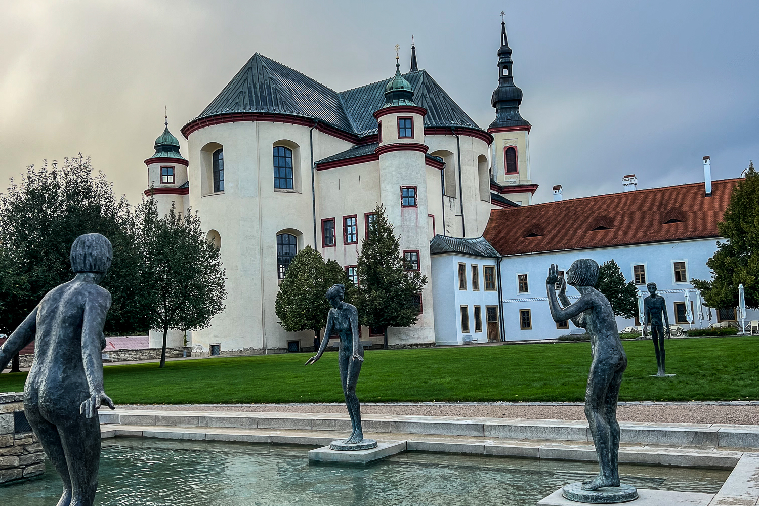 A catholic church in Czech Republic with statues and a water feature