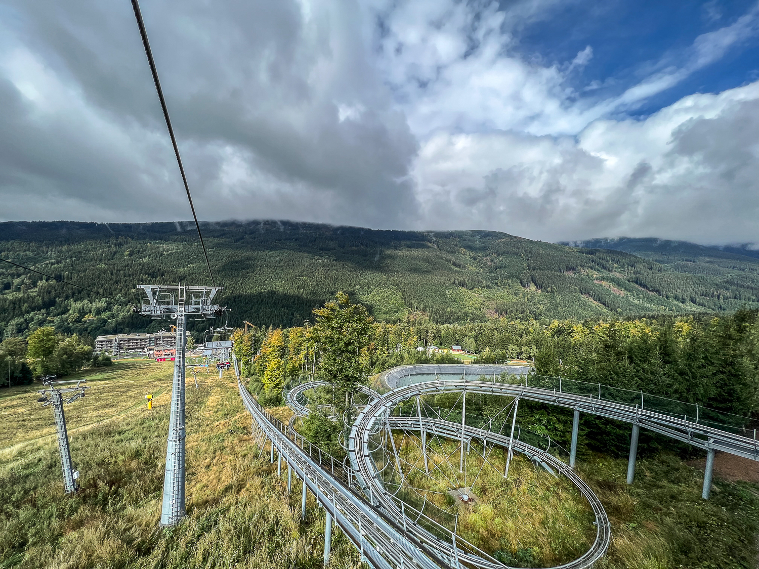 Panoramic view from a chairlift - Mountains and and alpine coaster track