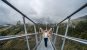 Girl standing with her arms up on the Skybridge721 in Dolni Morava