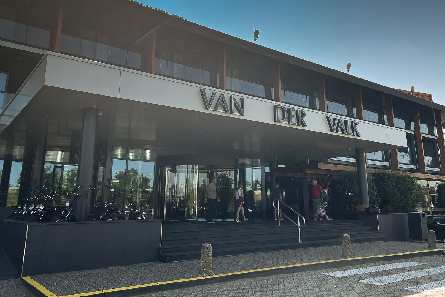 Front entrance of Hotel Van der Valk in Breukelen with people entering and exiting through the revolving doors