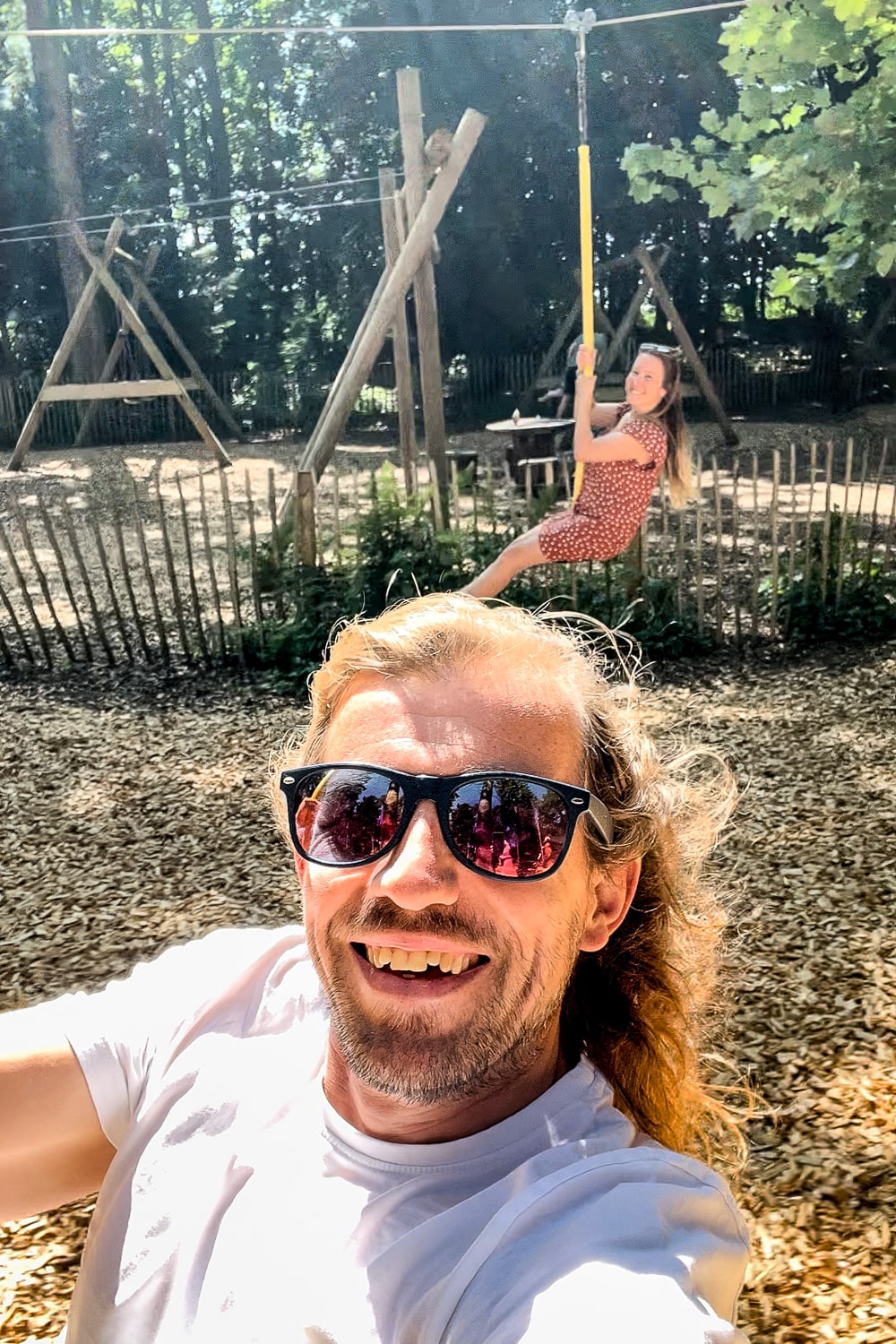 a selfie of a couple on playground ziplines