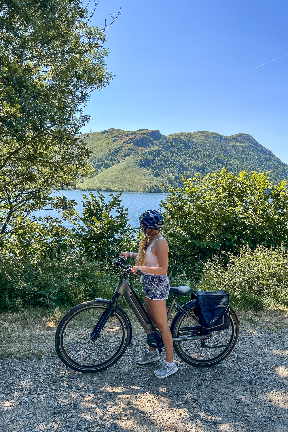 a girl on an ebike next to a lake