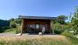 a woman sat outside a glamping house