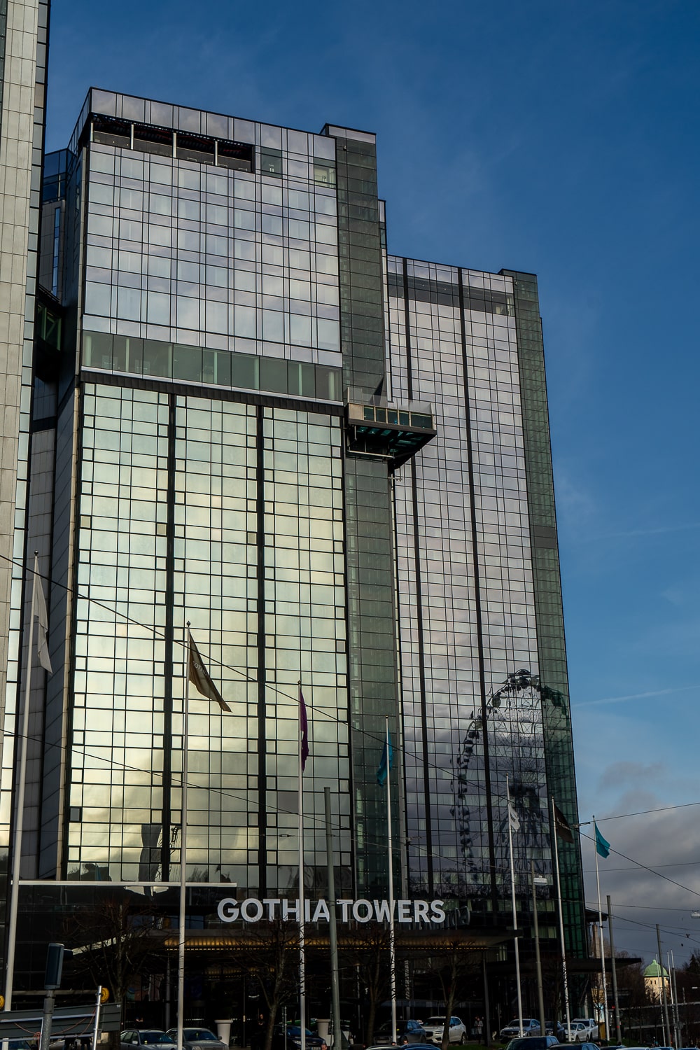 A large mirrored glass hotel with the name Gothia Towers above the entrance and several flags