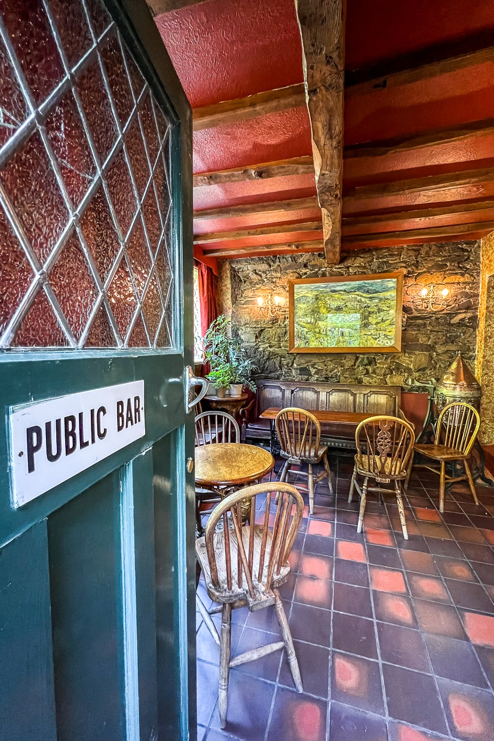 a small pub with stone walls and wooden ceiling