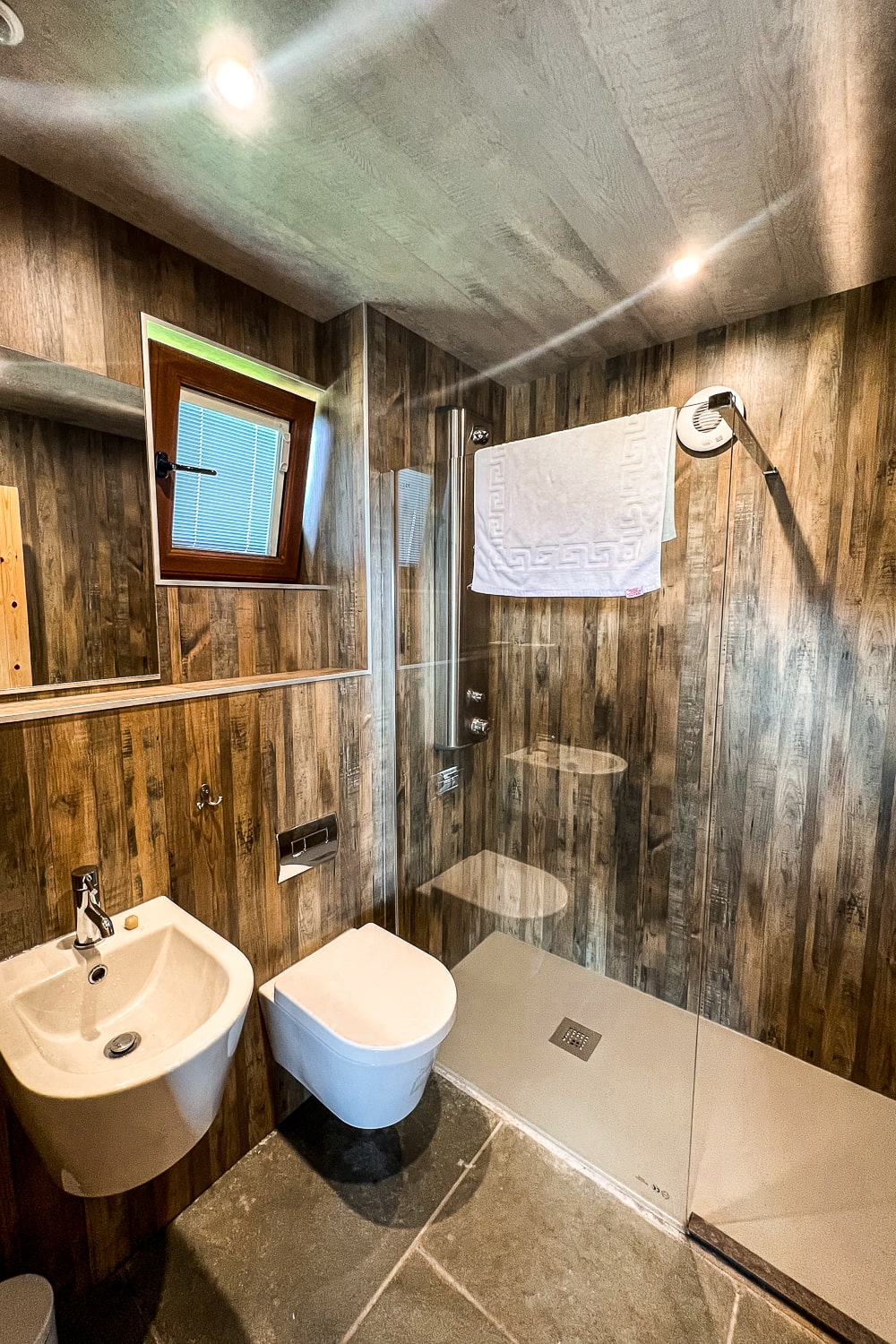 the bathroom of a glamping pod with sink, toilet, and shower