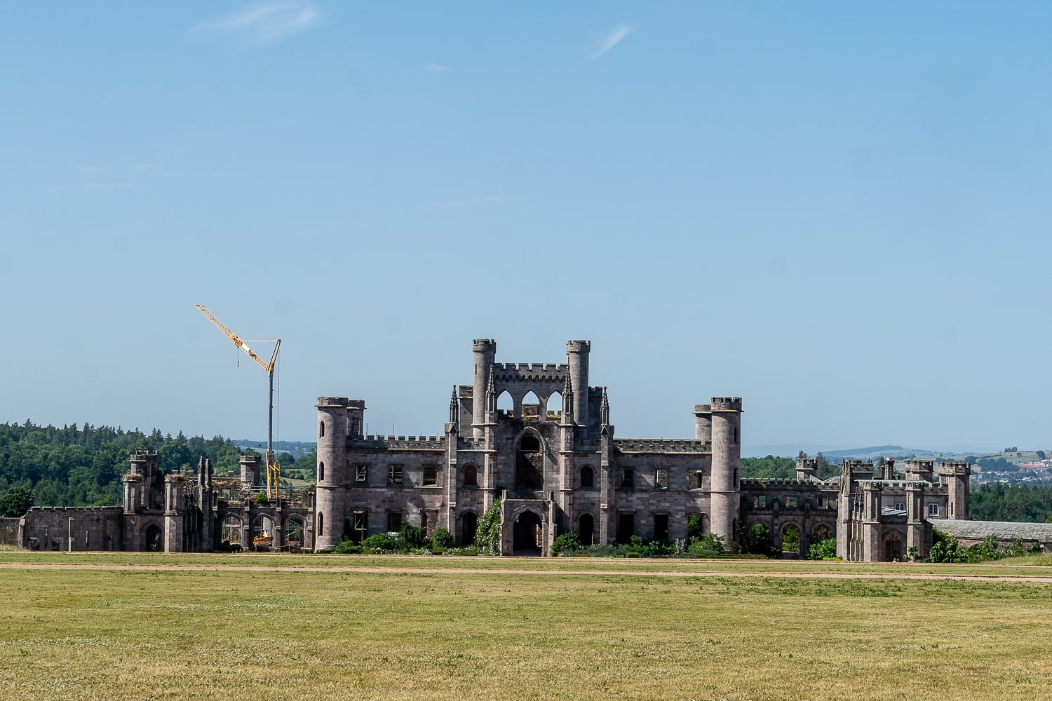 a large gothic castle with lawn