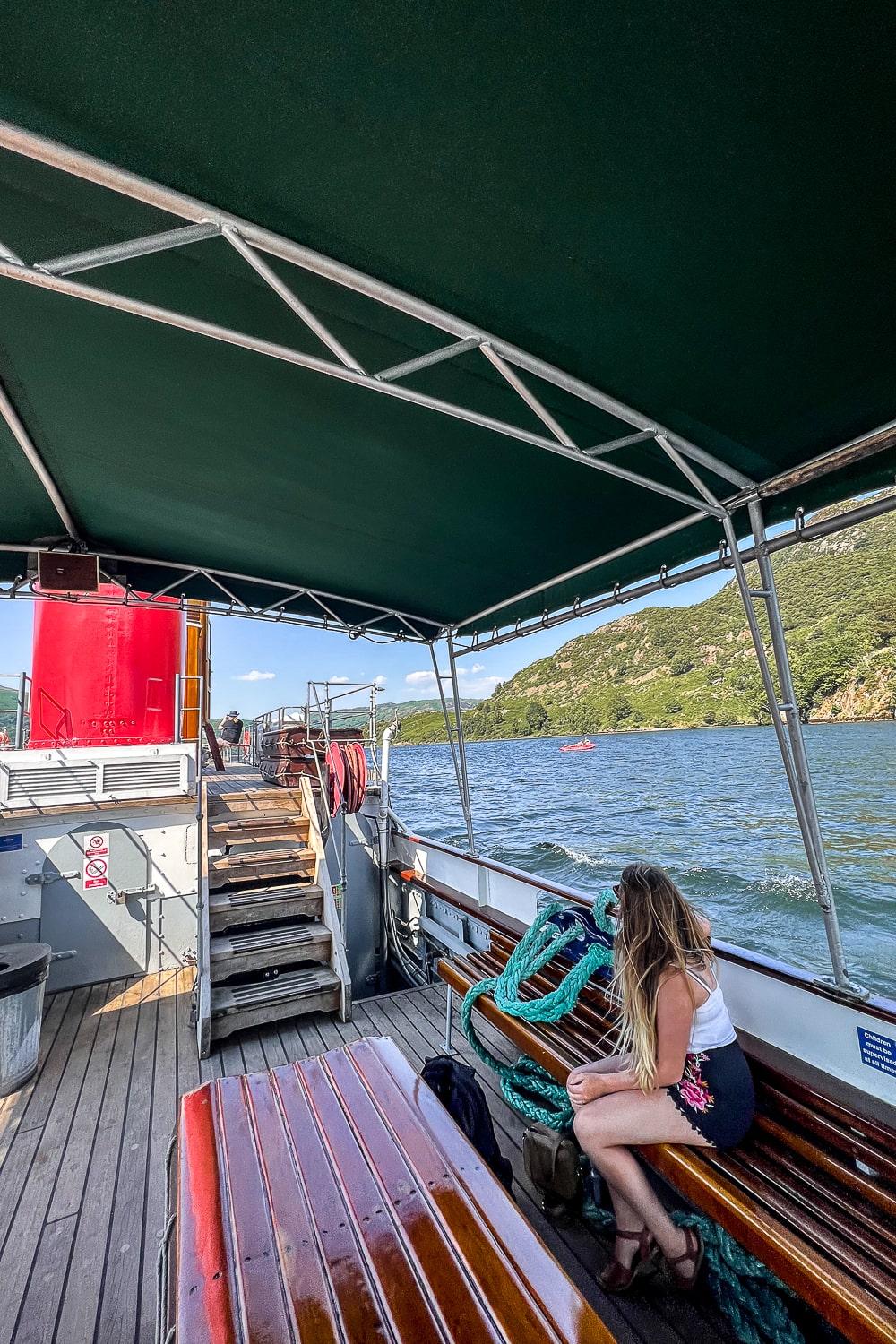 a girl sitting on a steam boat