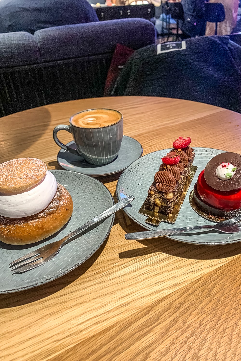 Two indulgent cakes with a coffee on a wooden table