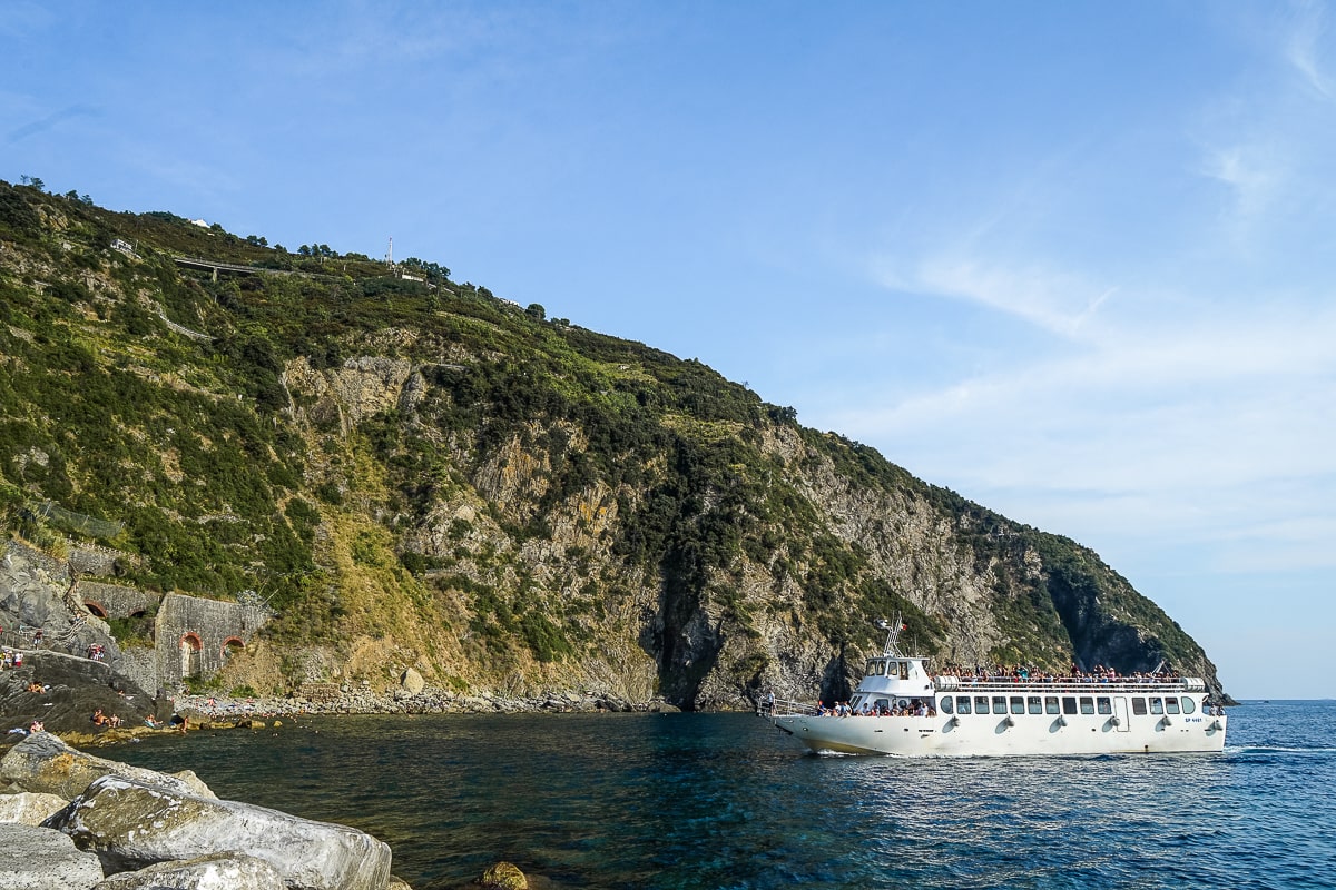 A long white ferry heading towards land