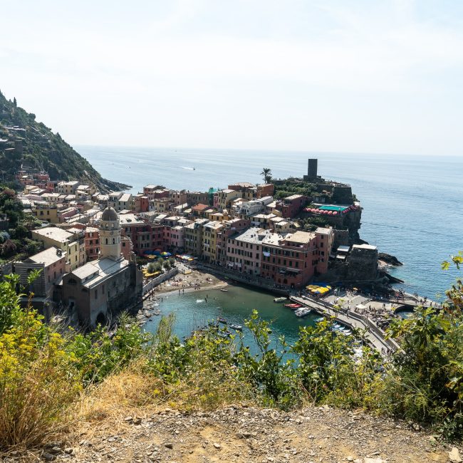 A cliff viewpoint of the beautiful town of Vernazza with colorful houses and a small bay