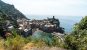 A cliff viewpoint of the beautiful town of Vernazza with colorful houses and a small bay
