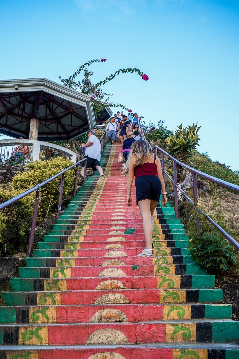 A woman walking up a colorful set of steps