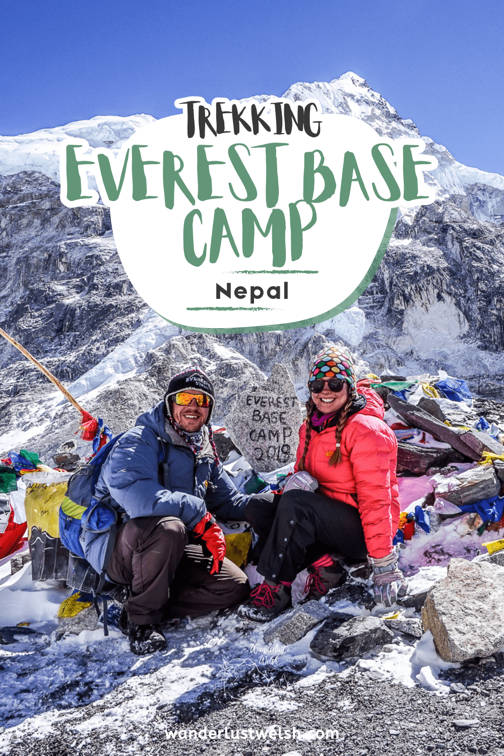 A couple at the Everest Base Camp 2019 stone marking the base camp with the words "Trekking Everest Base Camp" superimposed