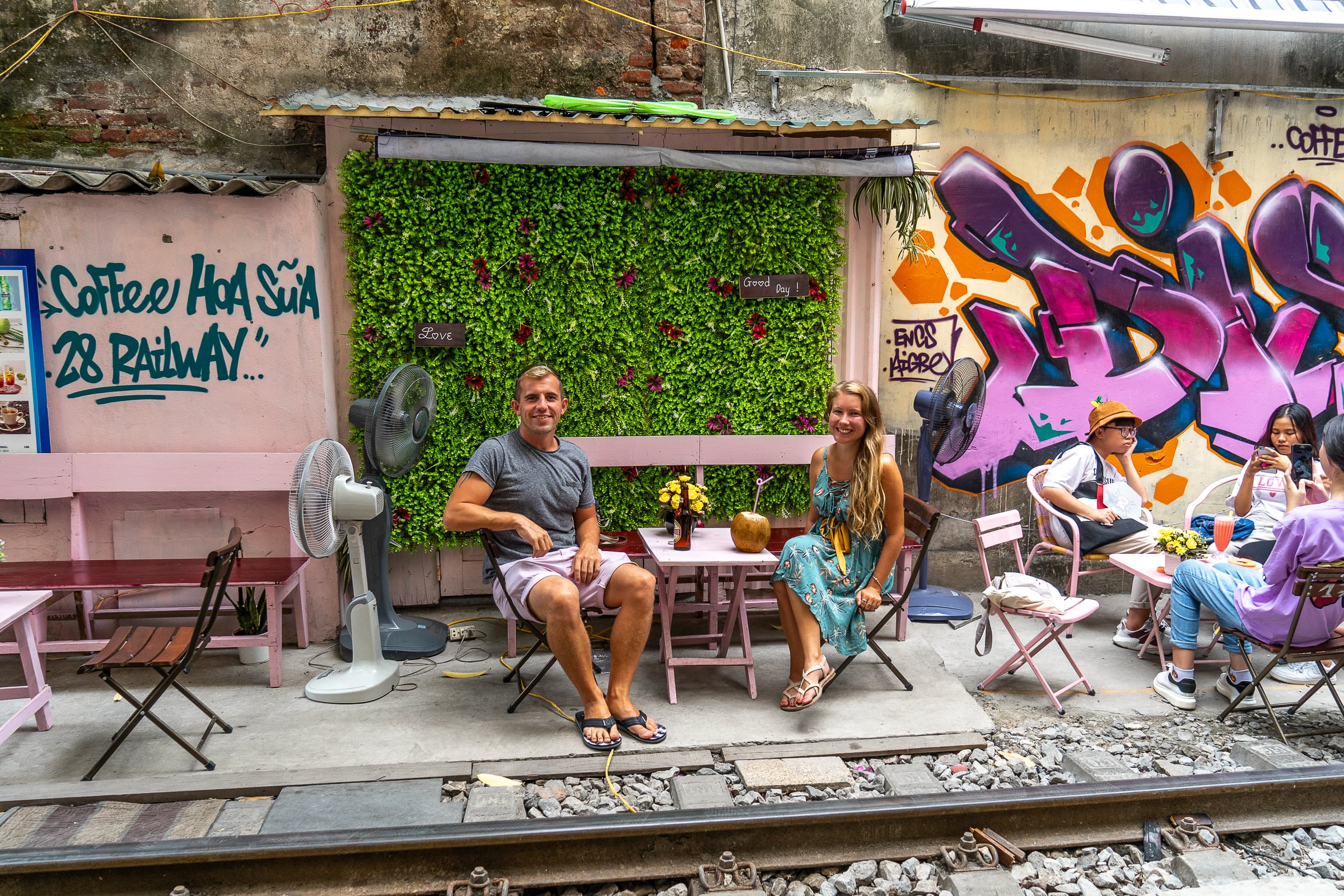 A couple sat at a cafe on Train street in Hanoi