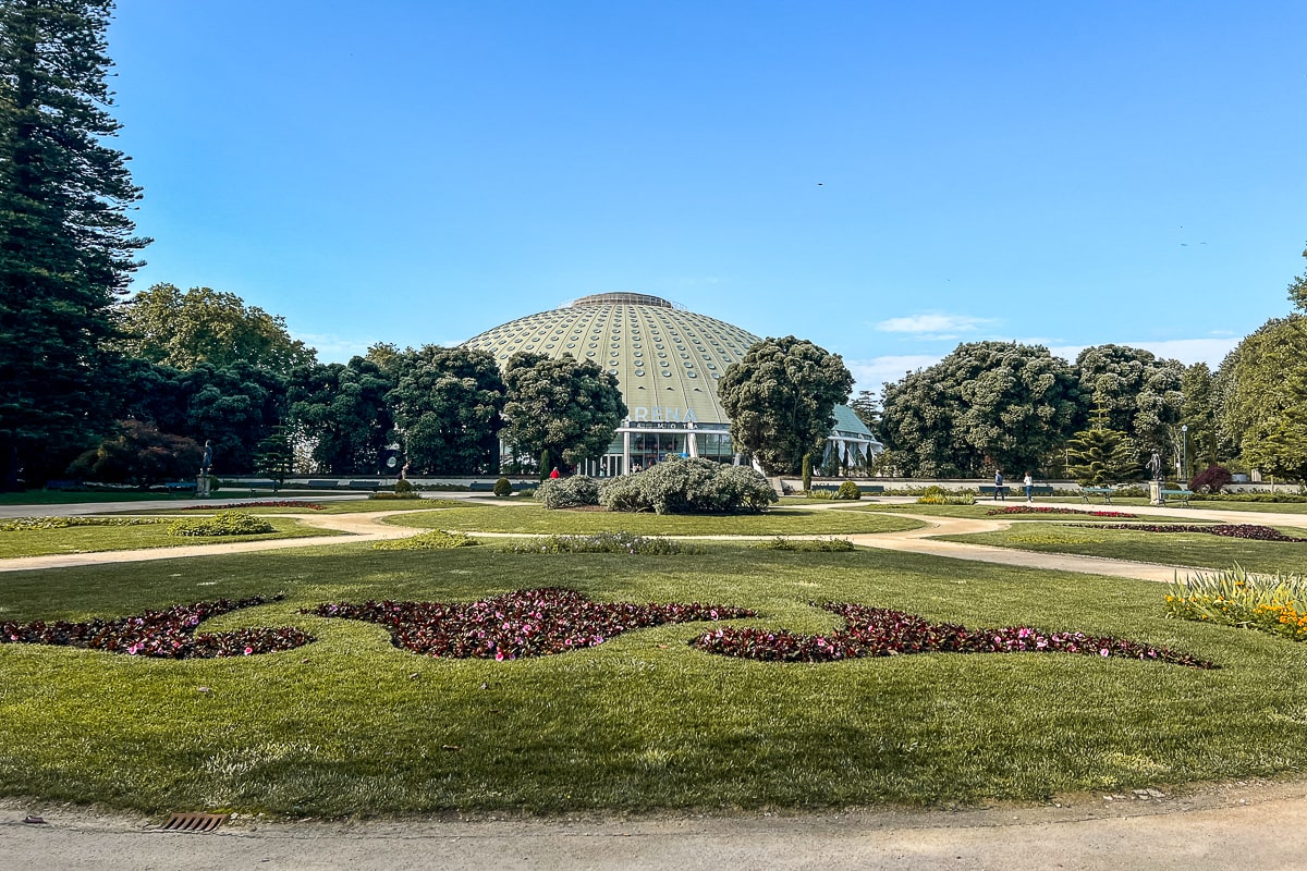 A green domed roof in a landscaped garden