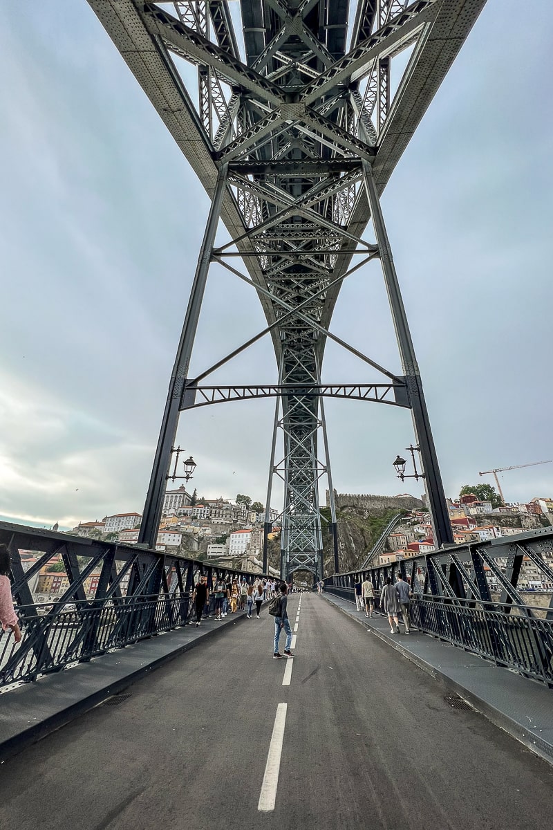 Directly underneath a criss-crossing iron bridge
