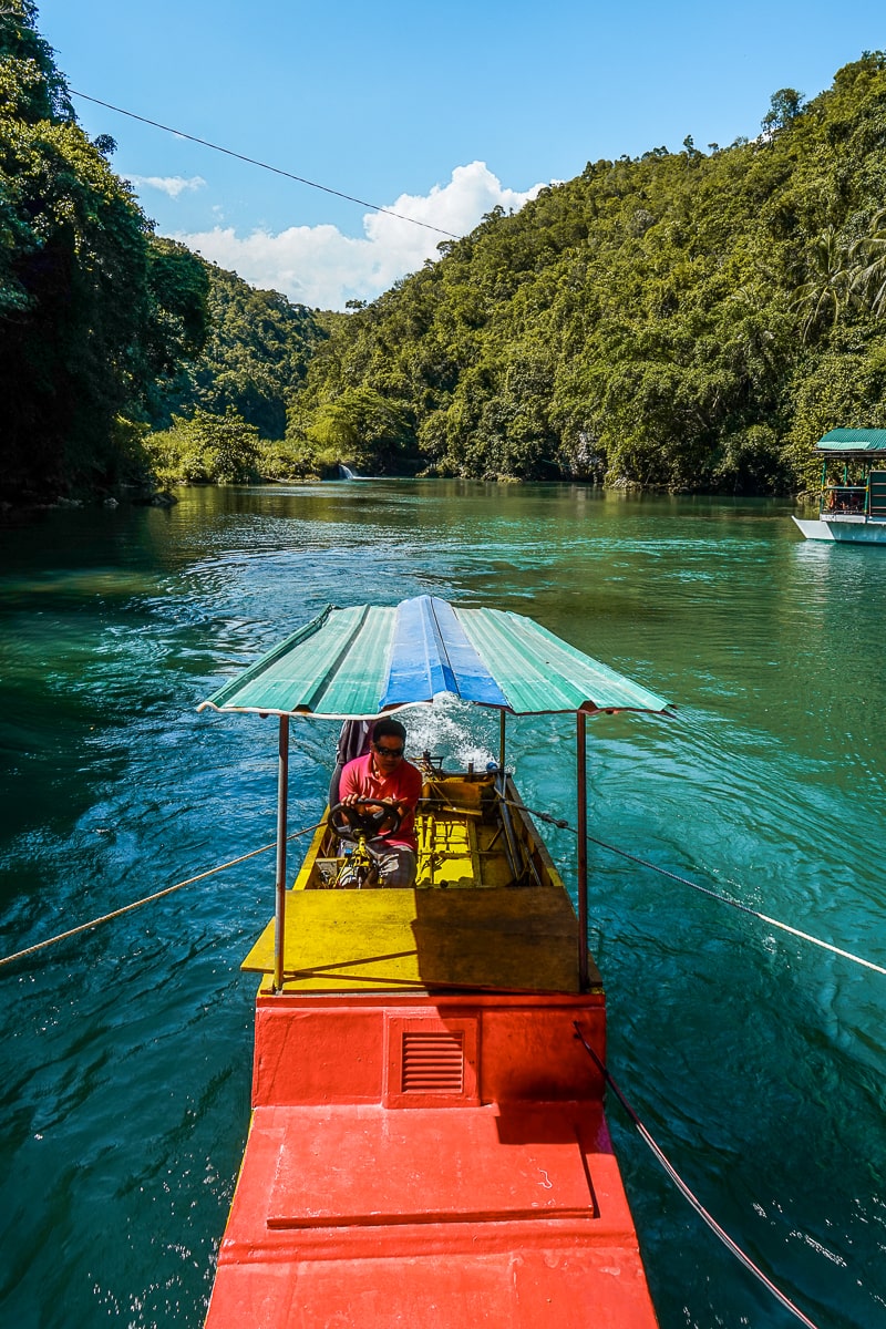 A view of the back of a river cruise boat with the driver