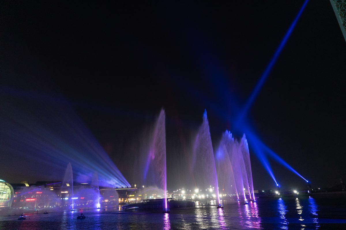 Blue and purple fountain and lights show at night