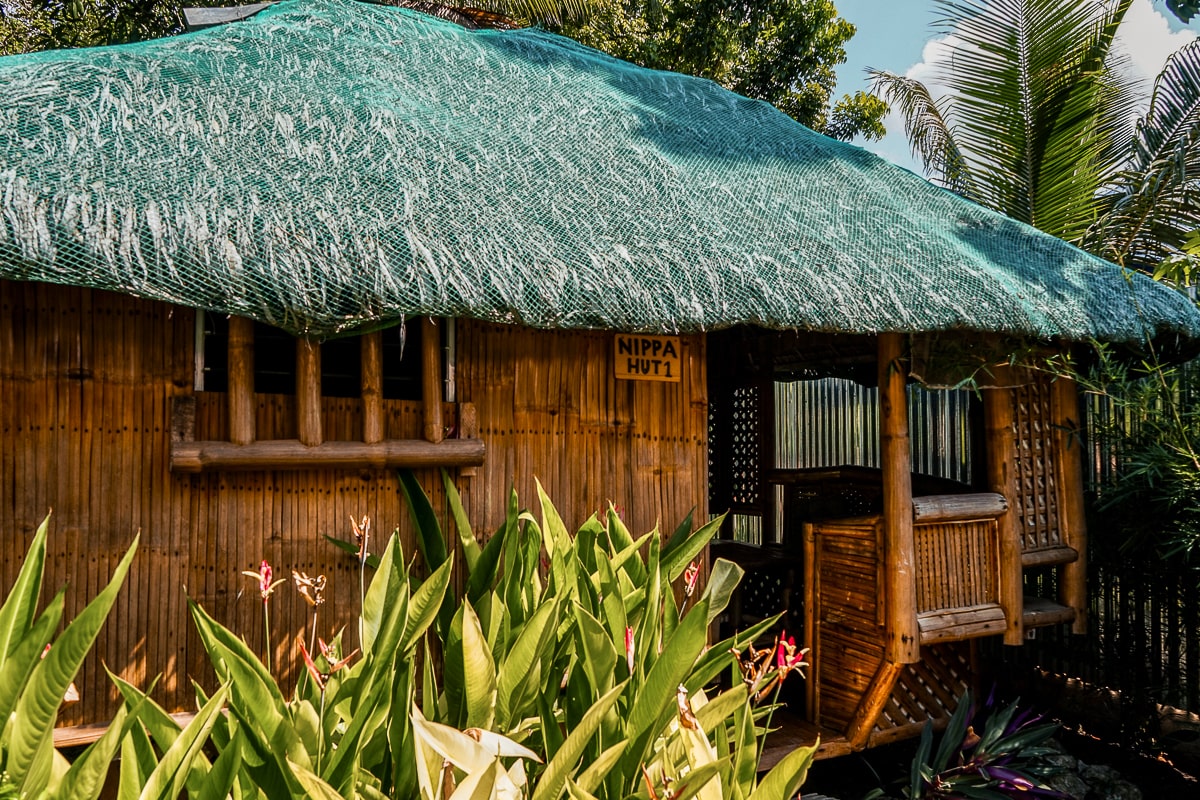 A traditional bamboo hut with banana leaf roof
