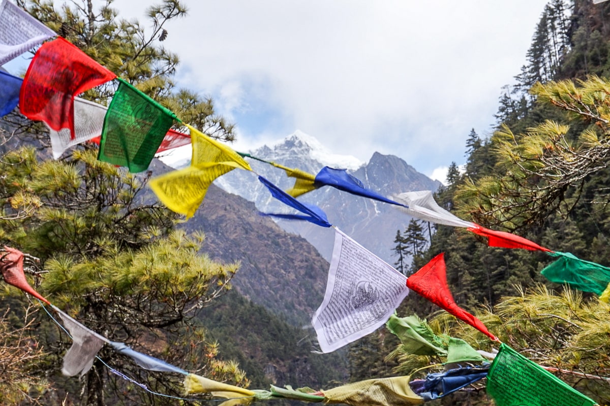 Colorful prayer flags with Himalayan mountains in the background
