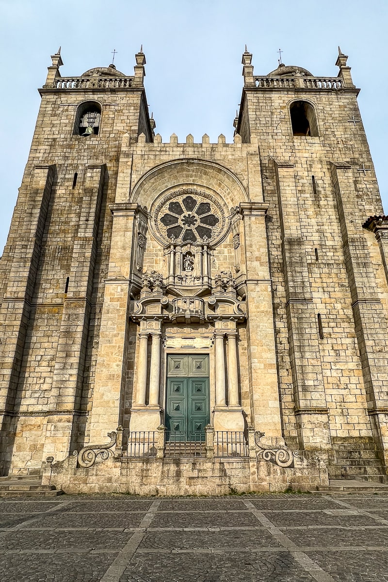 The front facade of the Porto cathedral a double tower with circular gothic window