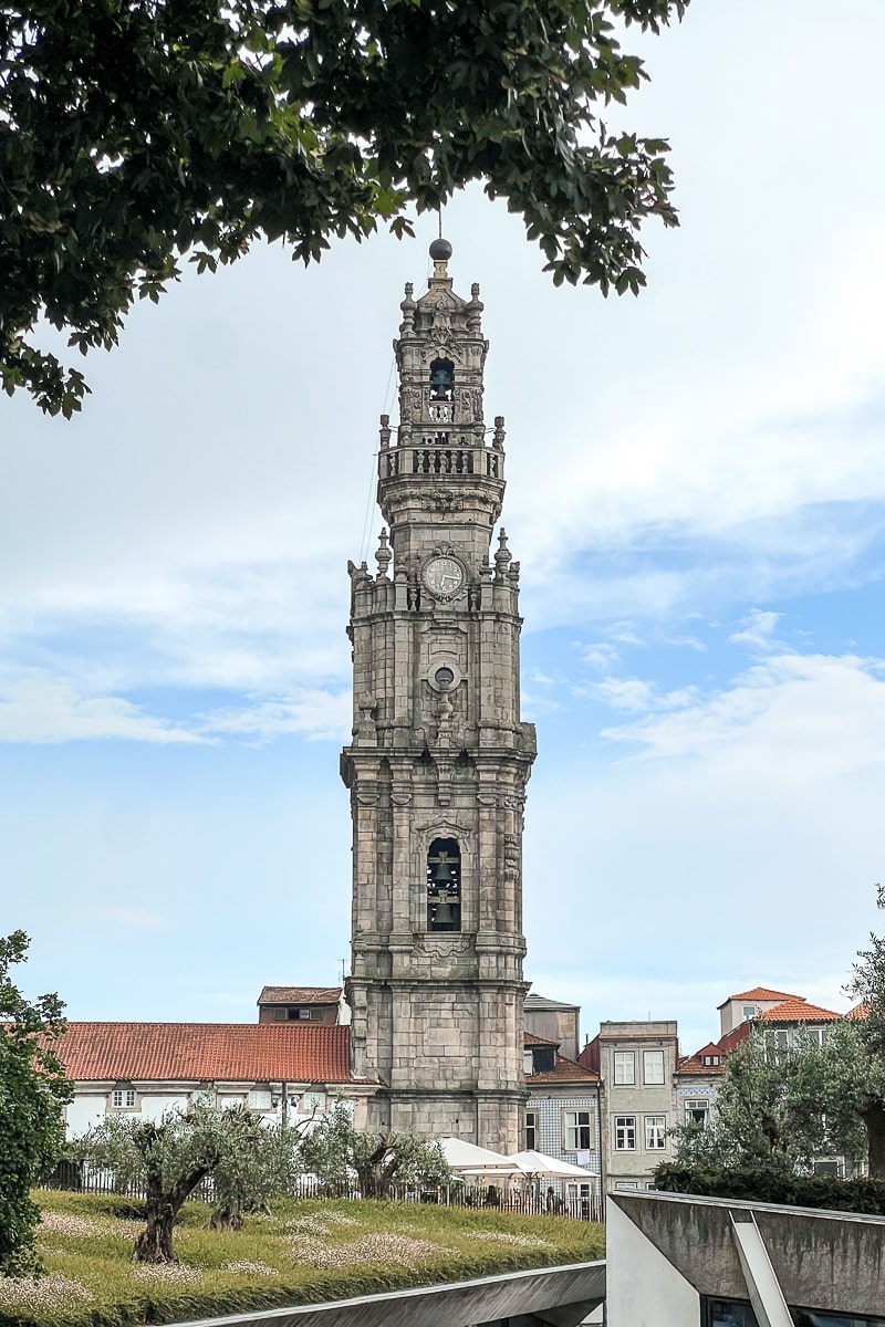 A stone tower framed by a tree