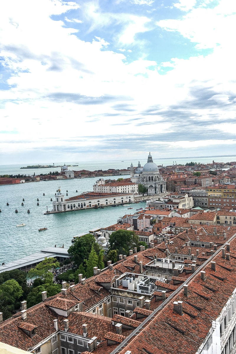 A view from St. Mark's Campanile in Venice of red rooftops and the sea