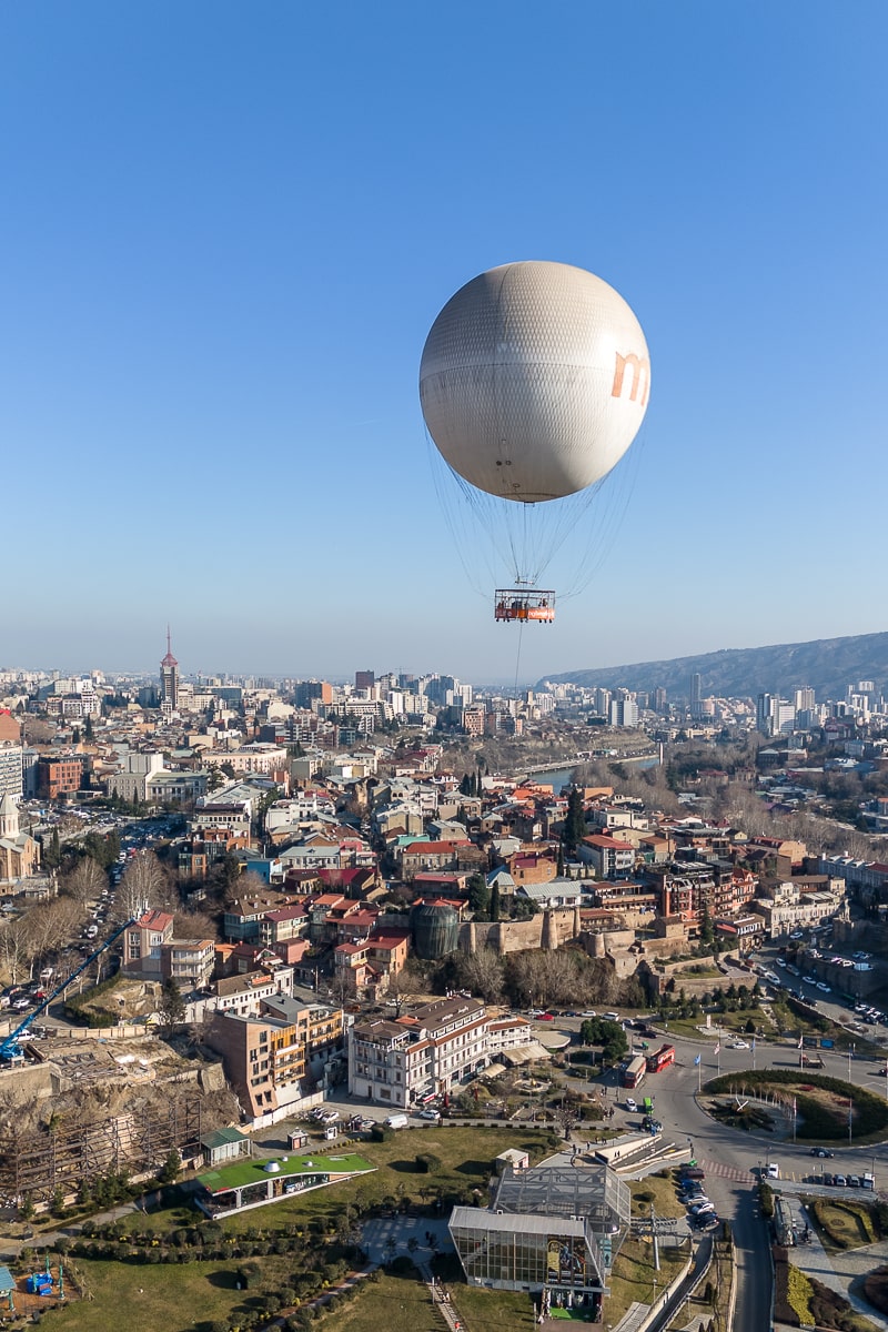 Large passenger air balloon flying over Tbilisi