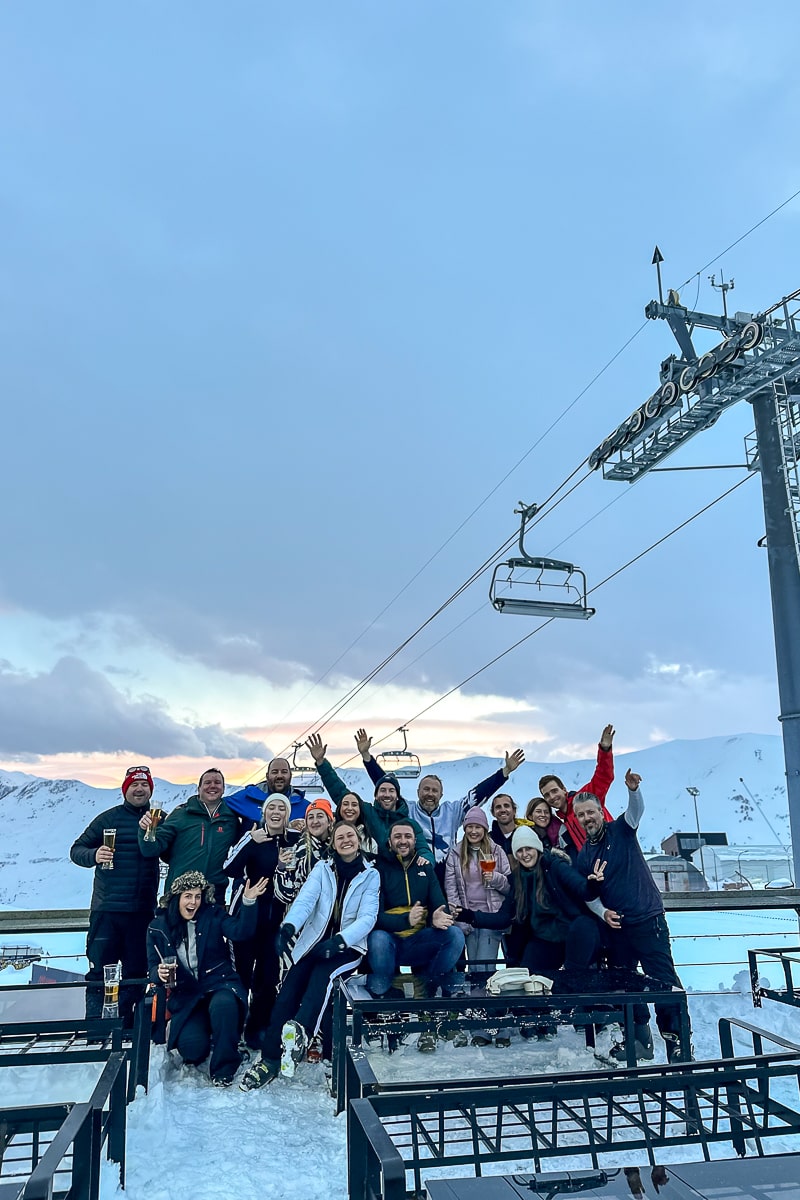A large group of friends enjoying apres-ski drinks on the slopes