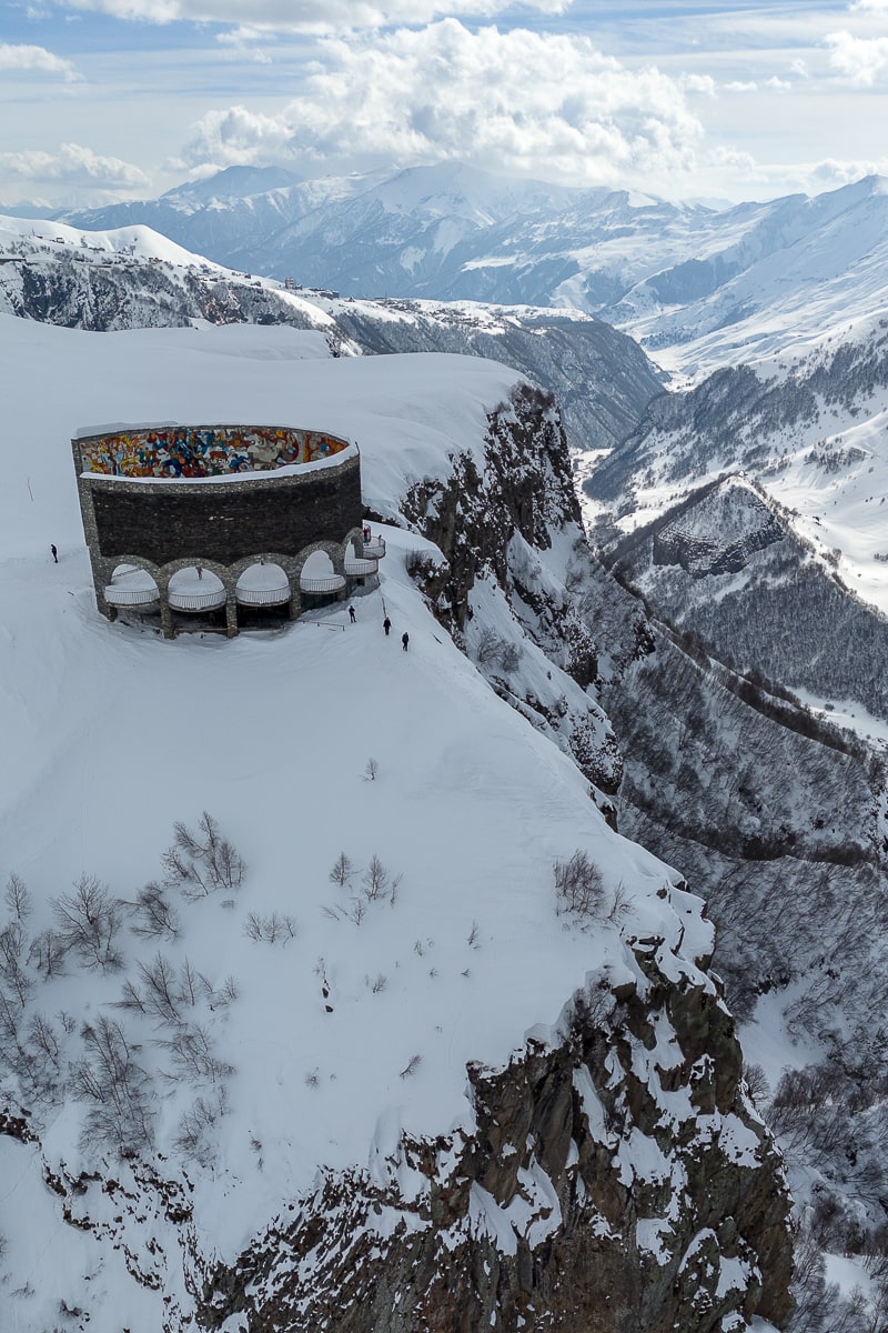 The circular stone Friendship Monument outside Gudauri, perched on a snowy cliff