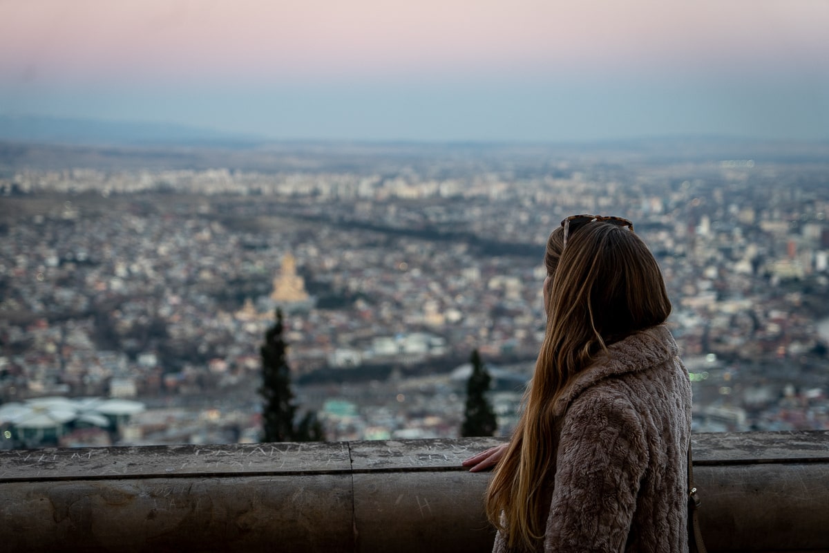 A girl standing looking out over Tbilisi from a viewpoint
