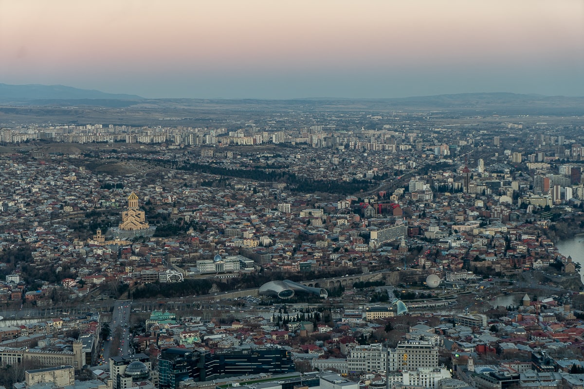 A panoramic shot of Tbilisi as the sun is setting