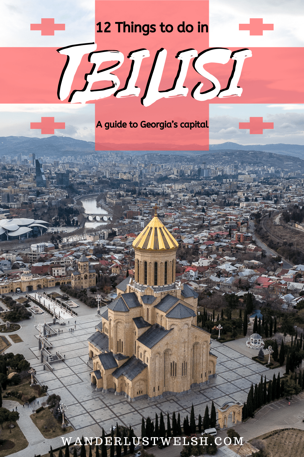 An aerial shot of the Eastern Orthodox cathedral with golden roof in Tbilisi and the city in the background